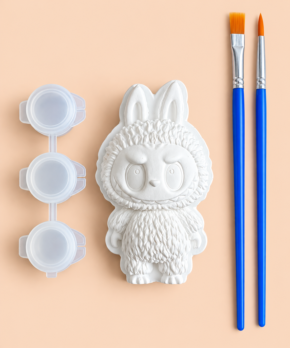 White bunny-eared plaster figure with three paint pots and two blue-handled brushes